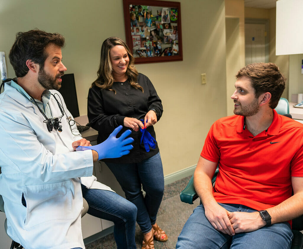 dentist and associate talking to patient